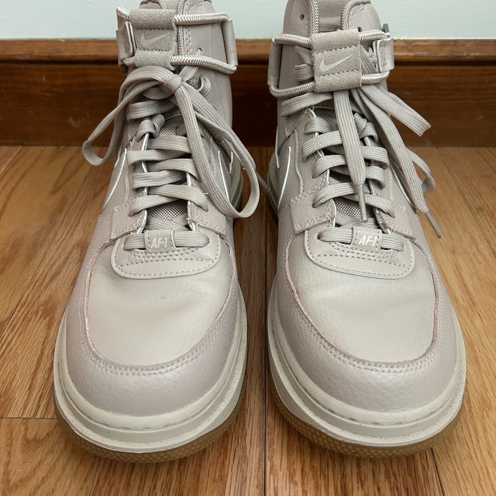 Nike women’s tan Air Force 1 High-Top Sneakers